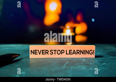 Never Stop Learning! on the sticky notes with bokeh background Stock Photo