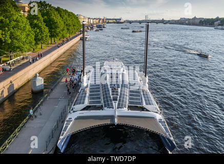 The French Catamaran Energy Observer against sights of the city, working for pure and renewables source of energy, solar energy, wind power, Admiralty Stock Photo