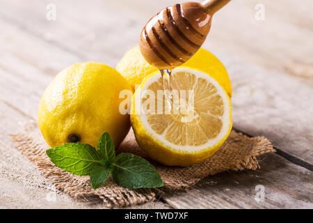 Fresh honey dripping on lemon Stock Photo