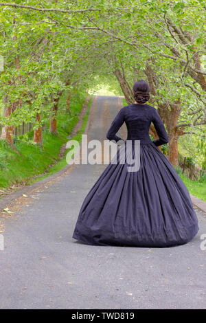 Dark-haired Victorian woman in black ensemble Stock Photo