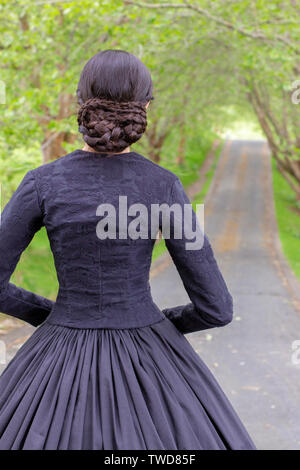 Dark-haired Victorian woman in black ensemble Stock Photo