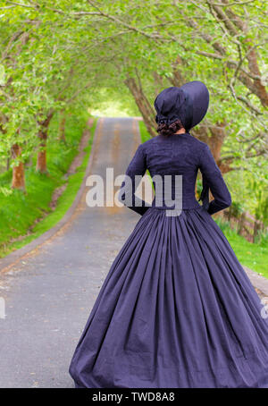Dark-haired Victorian woman in black ensemble Stock Photo