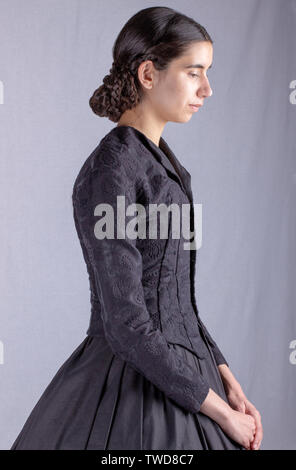 Dark-haired Victorian woman in black ensemble Stock Photo