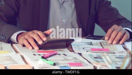 Businessmen count money and plan finances for projects and use calculators for analysis project documents and graph financial diagram working in the b Stock Photo