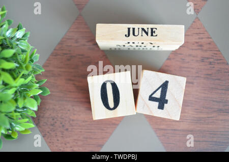Date of June with leaf on diamond pattern table for background. Stock Photo