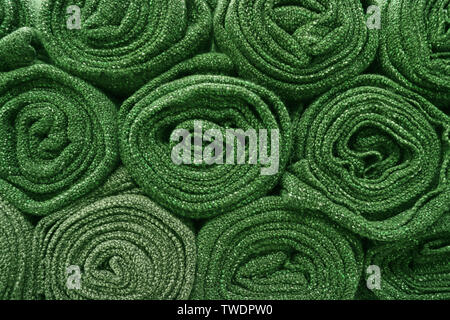 Heap of rolled up olive green blankets for background or banner Stock Photo
