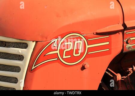 Close-up view of the streamlined logo on the hood of a vintage Cockshutt farm tractor, manufactured in the late 1950s in Brantford, Ontario, Canada. Stock Photo