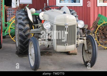 Restored classic antique Ford farm tractor displayed at a Pacific Northwest U.S. county fair with other vintage farm machinery on Aug. 30, 2015. Stock Photo