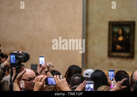 Paris, France, Oct 07, 2018 Louvre Museum, tourists using cameras, mobile phones over heads, taking pictures Mona Lisa La Gioconda Leonardo da Vinci Stock Photo