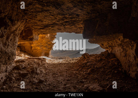 cave in the rocky desert landscape at El Ghessour, Tassili du Hoggar ...