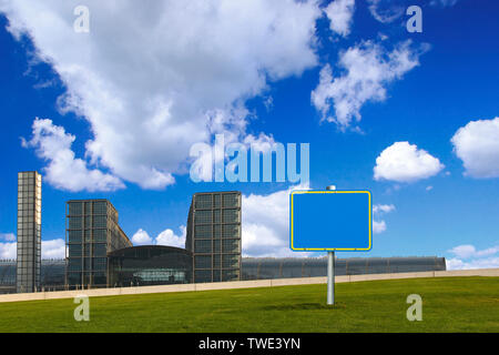 Sign board in a park with office building in the background Stock Photo