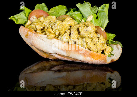 CHICKEN CURRY BAGUETTE with reflection isolated on black background. Studio Shot Stock Photo