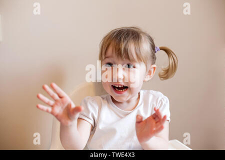 closeup face portrait of amazed little white girl on wall background Stock Photo