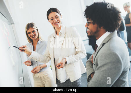 Diverse group of focused work colleagues during a planning and strategy meeting in office Stock Photo