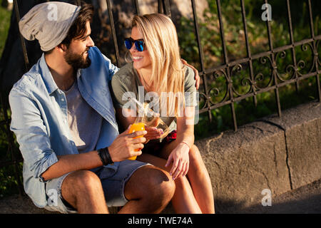 Couple drinking and having fun in the city. Summer holidays and dating concept Stock Photo