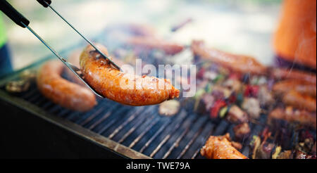 Grilled meat with vegetables over the coal on barbecue Stock Photo