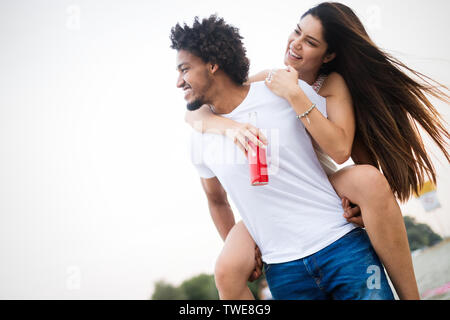 Smiling couple having fun over sky background. Holidays, vacation, love and friendship concept