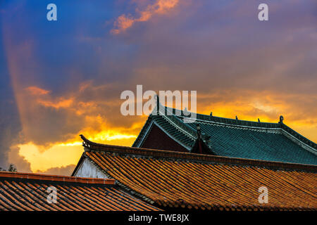 The light shines on the roof of the old building. Stock Photo