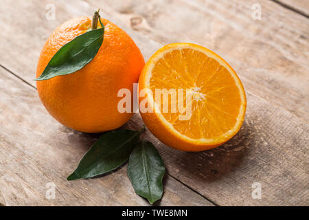 Fresh oranges on the table, one and half oranges on the table Stock Photo