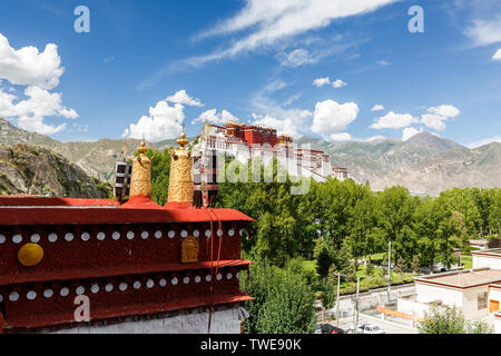 View on Potala Palace with golden prayer wheel in the foreground. Magnificent, breathtaking. Unesco World Heritage and center of tibetan buddhism. Stock Photo