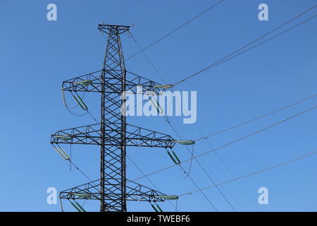 High voltage power line supports with electrical wires isolated on blue sky. Electricity transmission lines, power supply concept Stock Photo