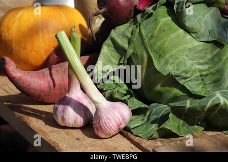 Fresh garlic, cabbage, beets and pumpkin on a wooden table. Background with vegetables, vegetarian diet, nutrition concept Stock Photo