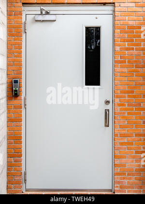 Electric door with digital lock on brick wall background vertical style. Stock Photo