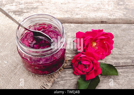 Jam rose petals on a wooden table. Flower confiture. Healthy food. Copy space Stock Photo