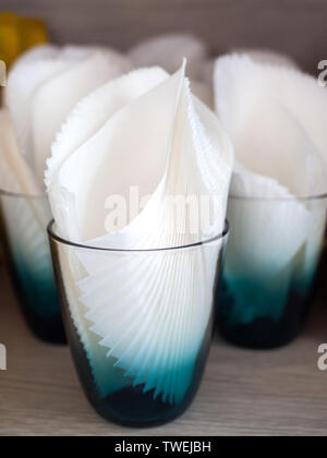 White clean tissue paper in retro style glass on wooden table vertical style. Stock Photo