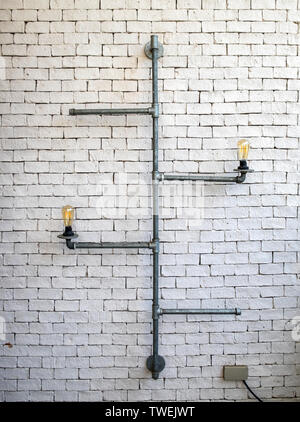 Tube decorate lamp vintage on brick white wall Stock Photo