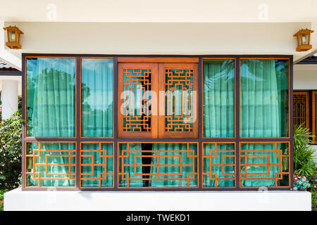 Wooden window and green curtain chinese tracery design Stock Photo