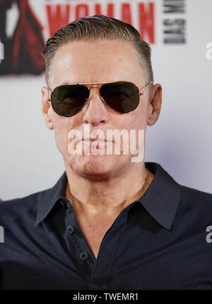 19 June 2019, Hamburg: Bryan Adams, Canadian rock singer, guitarist, composer and photographer, stands in front of a logo wall at a photo shoot for the kick-off event 'Pretty Woman - The Musical' at the Kehrwieder Theater. The Broadway musical will celebrate its European premiere in Hamburg on 29 September. Photo: Georg Wendt/dpa Stock Photo