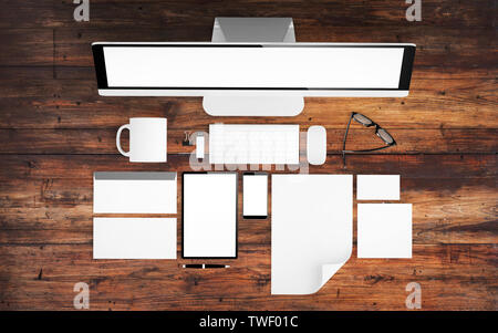 top view of devices and branding elements on wood desktop mockup 3d rendering Stock Photo