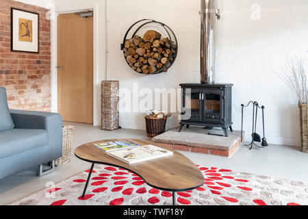 A wood burning stove in a modern barn conversion in the UK Stock Photo -  Alamy