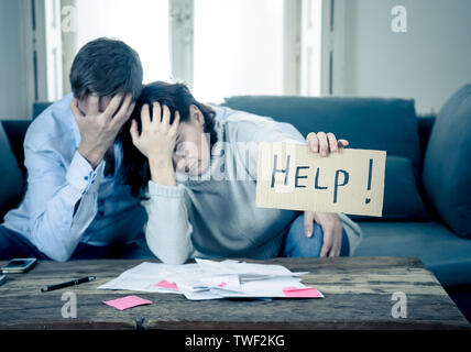 Stressed young couple needing help in accounting home finance paying bills mortgage bank statements and expenses feeling desperate having so many debt Stock Photo