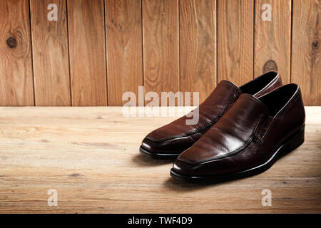 brown leather shoes for men, luxury leather shoes on wooden background Stock Photo