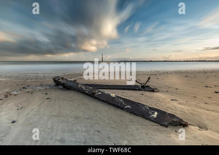 Broken sea defences laying on the beach at morning sunrise at Sea Palling in Norfolk. Stock Photo