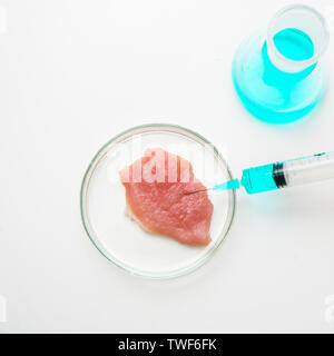Laboratory studies of meat in Petri dish. View from above. Chemical experiment. Stock Photo