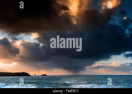 A dramatic fiery sky at sunset over Fistral in Newquay in Cornwall. Stock Photo