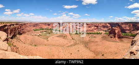 Canyon de Chelly, Arizona, Navajo nation, United States. Panoramic view of the red rocks and sand, blue sky background Stock Photo