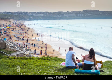 Holidaymakers relaxing on the coast overlooking Fistral Bay in Newquay in Cornwall. Stock Photo