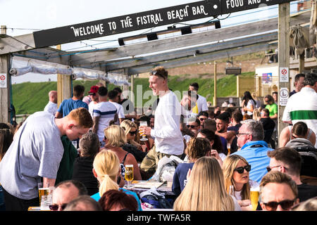 Holidaymakers relaxing with drinks at the Fistral Beach Bar in Newquay in Cornwall. Stock Photo