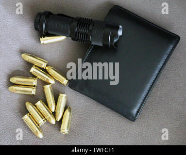 Tactical flashlight  pistol bullets and wallet Stock Photo
