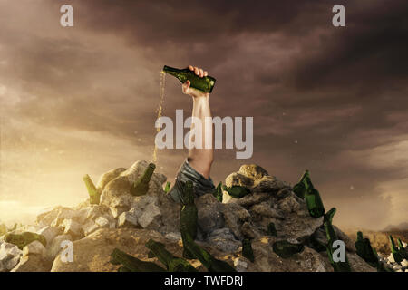 hand with green beer bottle raising up from rubbish dump and empty it to say stop alcoholism. Concept alcohol addiction Stock Photo