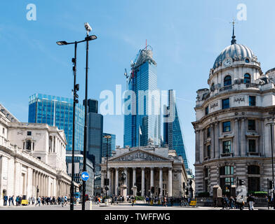 London, UK - May 14, 2019: The Royal Exchange and The Bank of England against skyscrapers in the City of London a sunny day Stock Photo
