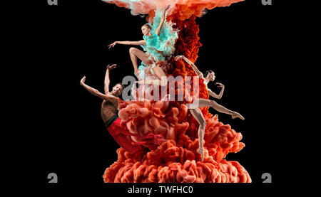 Abstract creative collage formed by color dissolving in water on black background. Bright combination of colors. Young dancers in clouds of smoke or dissolves. Graceful, flexibility and elegance. Stock Photo