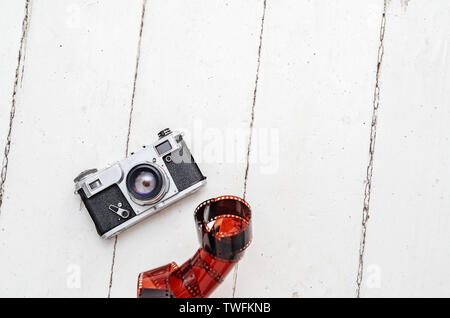 Old film camera on white boards. Vintage equipment. Stock Photo