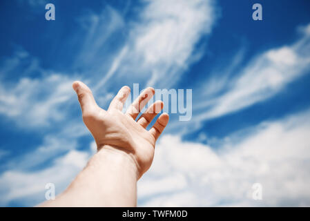 Man holding his arm towards the sky Stock Photo