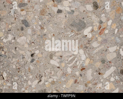 Grinded concrete texture with exposed gravel stones Stock Photo