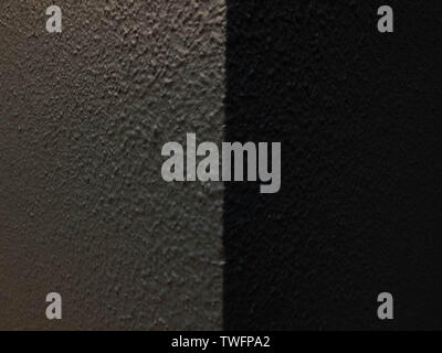Black plastered textured wall. Light and shadow side Stock Photo